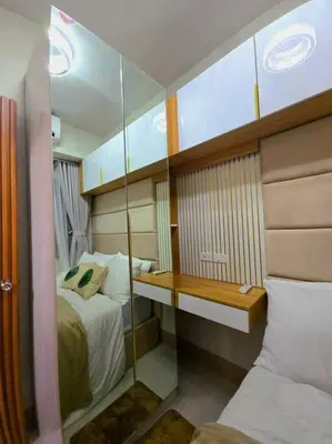 a small bedroom with a bed and a mirror at Cozy apartment near Airport in Shore 3 in Manila