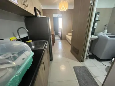 a small kitchen with a sink and a refrigerator at Shore 2 2-Bed Balcony City View WiFi Netflix near MOA 834 in Manila