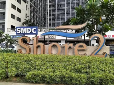 a large sign that says slow in a city at Shore 2 2-Bed Balcony City View WiFi Netflix near MOA 834 in Manila