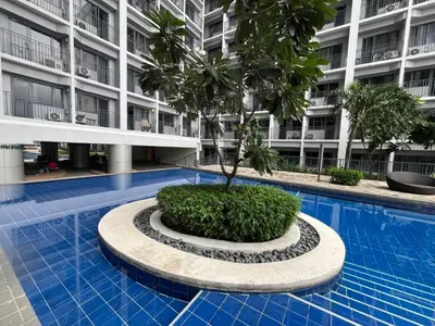 a palm tree in the middle of a swimming pool in a building at Shore 2 2-Bed Balcony City View WiFi Netflix near MOA 834 in Manila