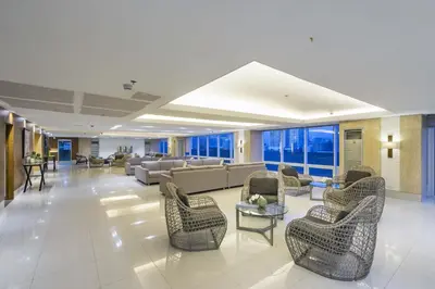 a lobby with couches and chairs in a building at SM Breeze one bedroom in Manila