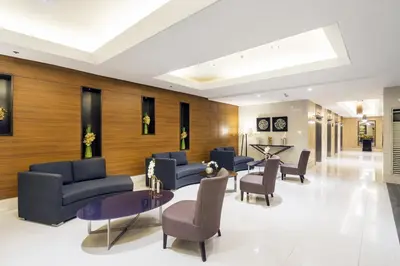 a lobby with couches and chairs and a table at SM Breeze one bedroom in Manila