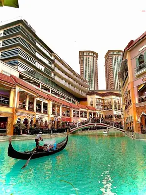 a group of people in a gondola on a river in a city at 2 Bedrooms & 2 Bathrooms at BGC Taguig McKinley by Venice Grand Canal mall in Manila