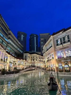 a gondola paddling through a canal in a city at 2 Bedrooms & 2 Bathrooms at BGC Taguig McKinley by Venice Grand Canal mall in Manila