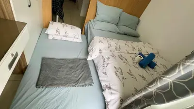 two bunk beds in a small room with at Kathys Crib with balcony Pool view at Shell Residence in Manila