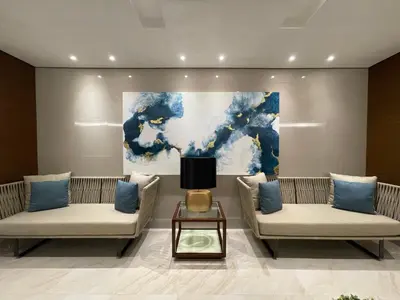 a lobby with two couches and a painting on the wall at Coast Residences Near MOA and NAIA Manila Bay View with Pool in Manila