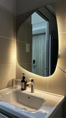 a bathroom with a sink with a large mirror at Coast Residences Near MOA and NAIA Manila Bay View with Pool in Manila