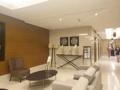 a living room with a couch and a table at SkyViewCondotel Breeze Residences Staycation near WTC,PICC,MOA,NAIA,OCEAN PARK in Manila