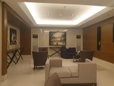 a living room with a white couch and chairs at SkyViewCondotel Breeze Residences Staycation near WTC,PICC,MOA,NAIA,OCEAN PARK in Manila