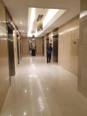 a man standing in a hallway in a building at SkyViewCondotel Breeze Residences Staycation near WTC,PICC,MOA,NAIA,OCEAN PARK in Manila