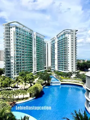 a view of a resort with a large swimming pool at azure urban resort residences in Manila