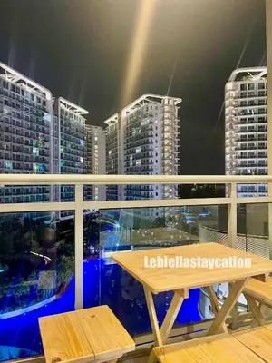 a table on a balcony with a view of buildings at azure urban resort residences in Manila