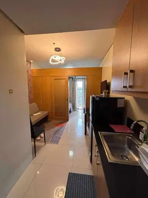 a kitchen with a sink and a counter top at Shell Residences Condotel Apartment in Manila