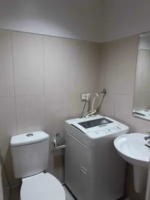 a small bathroom with a toilet and a sink at Shell Residences Condotel Apartment in Manila