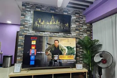 a tv in a room with a stone wall at Near Manila Airport COZY 02 Bedroom Condo With Pool - 4R in Manila