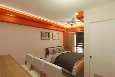 a bedroom with a bed and a table and chairs at Near Manila Airport, COZY Hotel Style Studio Condo 5G in Manila