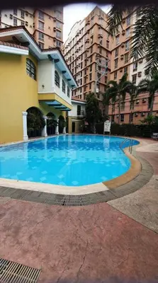 a large blue swimming pool in front of a building at Near Manila Airport, COZY Hotel Style Studio Condo 5G in Manila