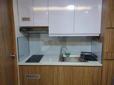 a kitchen with a sink and a white cabinet at Near Manila Airport, COZY Hotel Style Studio Condo 5G in Manila