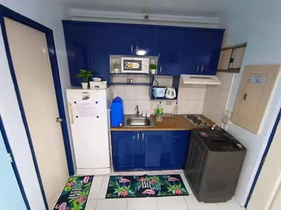 a small kitchen with a sink and a refrigerator at Near Manila Airport COZY 01 Bedroom Condo - 10L in Manila