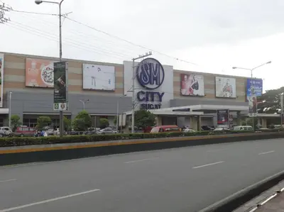 a building with a city sign on the side of a street at Near Manila Airport COZY 01 Bedroom Condo - 10L in Manila