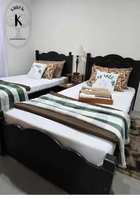 two beds in a room with towels on them at Sleep With Me Room cozy stay near Araneta Center in Manila