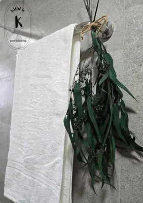 a towel with a bunch of green leaves on it at Sleep With Me Room cozy stay near Araneta Center in Manila