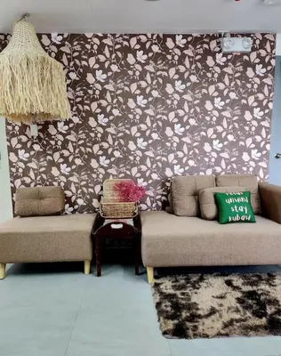 a living room with two couches and a patterned wall at Sleep With Me Room cozy stay near Araneta Center in Manila