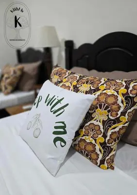 a pillow with the word wilson on it on a bed at Sleep With Me Room cozy stay near Araneta Center in Manila