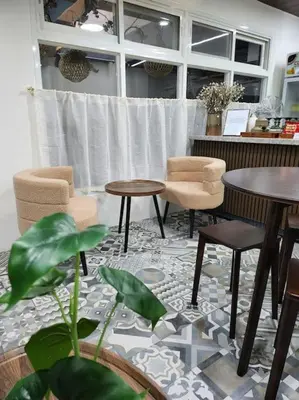 a room with two tables and two chairs and tables at Sleep With Me Room cozy stay near Araneta Center in Manila