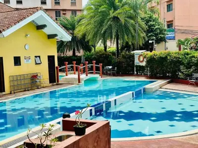 a large swimming pool with blue water in a building at Near Manila Airport COZY 01 Bedroom Condo - 10K in Manila
