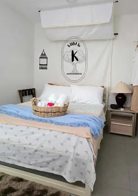 a bedroom with a bed with a basket of towels at Tranquil Haven Relaxing Retreat near Araneta in Manila