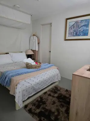a bedroom with a bed with a basket on it at Tranquil Haven Relaxing Retreat near Araneta in Manila