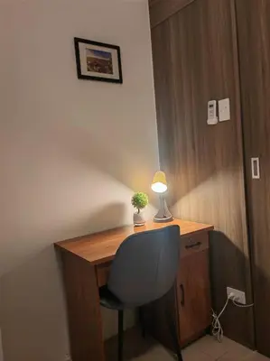 a desk with a chair and a lamp on it at 1BR Condotel with Balcony at FAME Residences #FM55 in Manila