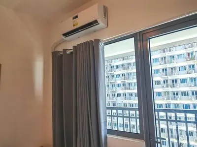 a window with a view of a tall building at 1BR Condotel with Balcony at FAME Residences #FM55 in Manila