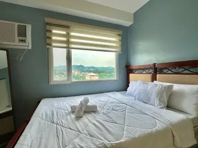 a bedroom with a bed with a stuffed animal on it at Luna Hive Place in Malapandan