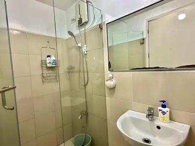 a bathroom with a shower and a sink and a mirror at Luna Hive Place in Malapandan