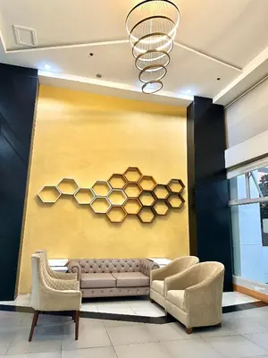 a living room with a couch and two chairs at Luna Hive Place in Malapandan