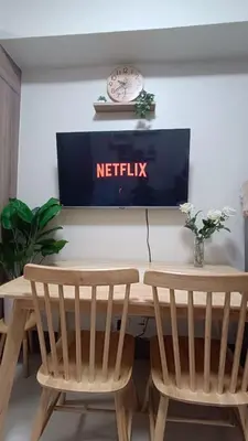 a table with two chairs and a netflix sign on a wall at Cozy Staycation at Destiny's Crib Fame, Edsa Mandaluyong in Manila