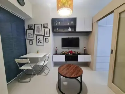 a living room with a table and a dining room at Jazz Residences Luxury Staycation in Manila