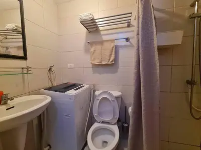 a small bathroom with a toilet and a sink at Jazz Residences Luxury Staycation in Manila