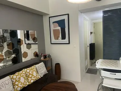 a living room with a couch and a table at Jazz Residences Luxury Staycation in Manila