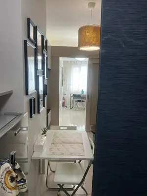 a kitchen with a table and chairs in a room at Jazz Residences Luxury Staycation in Manila