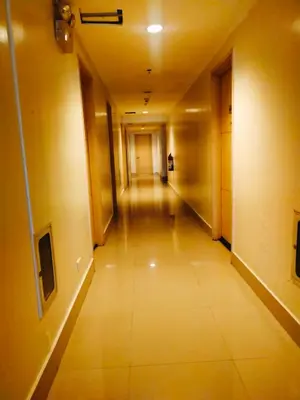 an empty hallway in an office building at Sea Residences Condotel GudStay in Manila