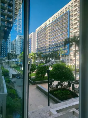 a view of a city from a window of a building at Sea Residences Condotel GudStay in Manila