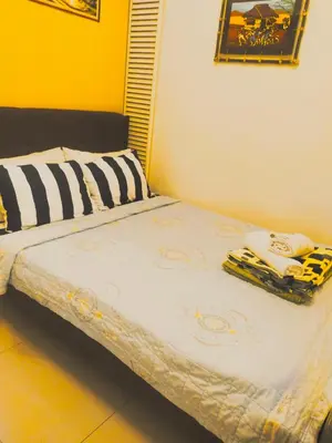 a bed with two towels sitting on top of it at Sea Residences Condotel GudStay in Manila