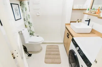 a small bathroom with a toilet and a sink at Excellent Location 2 BDRM Homey Wifi Near Airport in Manila