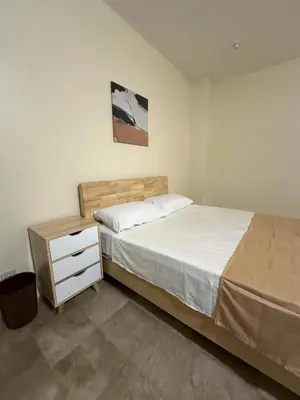a bedroom with a bed and a nightstand and a bed sidx sidx sidx sidx at W Spot Property in Manila