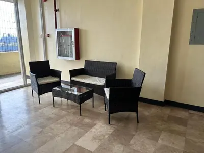 a waiting room with chairs and a table and a fire extinguisher at W Spot Property in Manila