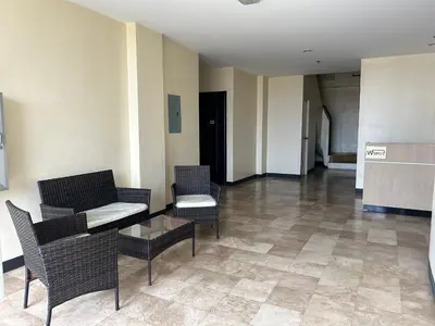a lobby with chairs and a couch and a table at W Spot Property in Manila