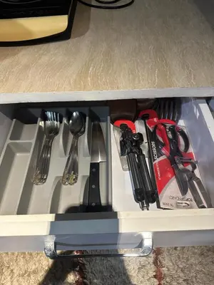a drawer filled with utensils on a shelf at Cozy Room with Citiview at Greenbelt Makati in Manila